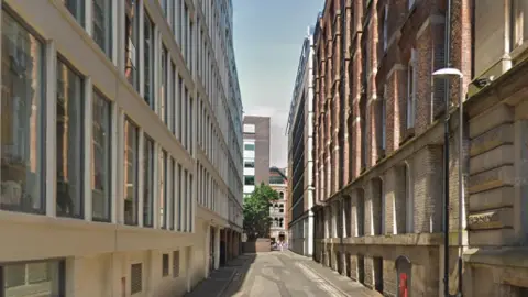 Streetview of alleyway with buildings along either side.