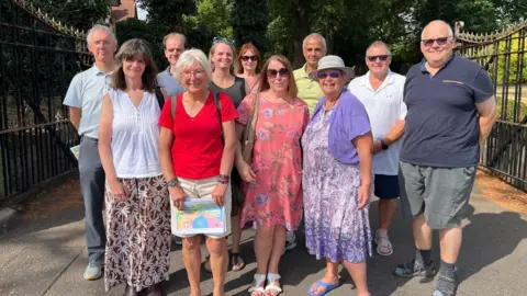 A group of residents stood in front of gates at a golf club