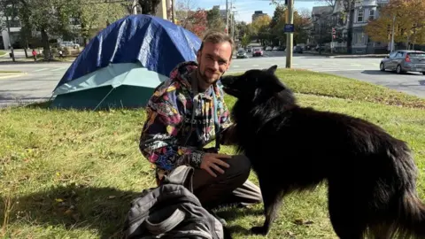 BBC Andrew Goodsell poses extracurricular  his structure   with his canine  successful  downtown Halifax