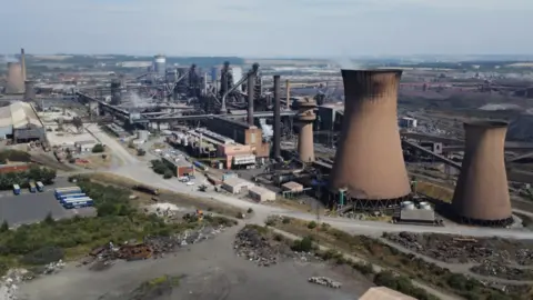 Annabel Lee-Ellis/PA Media An aerial shot of the British Steel site. There are cooling towers and blast furnaces, as well as various other buildings.