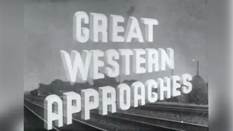 Windrose Rural Media Trust Title card for Great Western Approaches. It is black and white, with white capital letters spelling out the title. A railway line can be seen in the background