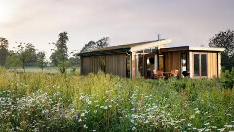 ILM Group An artist's impression of a proposed wooden-style lodge surrounded by wildflowers 