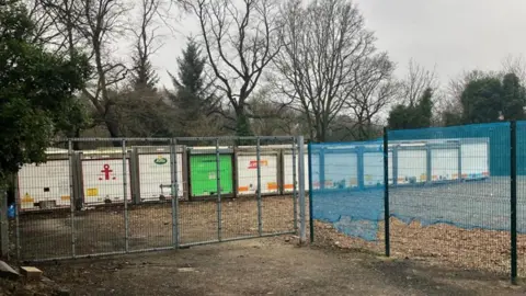 Large containers behind a gate