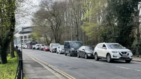 A queue of cars stuck in traffic