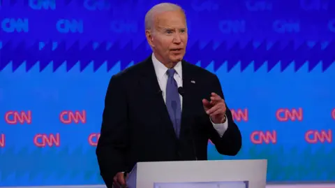 Reuters President Joe Biden motions with his hand while answering a question on the debate stage in Atlanta