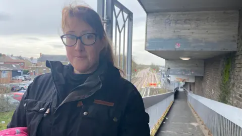 Sarah Sobey a young Mum standing in front of Ashington train station 