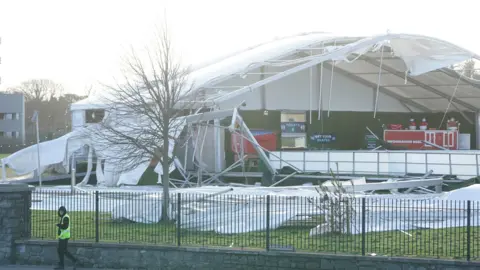 PA An ice skating facility in Blanchardstown has been destroyed after strong winds tore the structure apart. Residents across Ireland have been urged to stay at home as the entire island braces for the arrival of Storm Eowyn. The top-level red warning for wind is in place in both Northern Ireland and the Republic of Ireland.