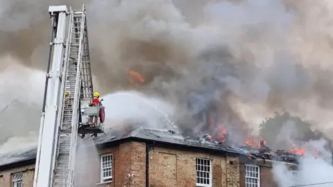 DWFRS Firefighters tackling the fire at The Stables