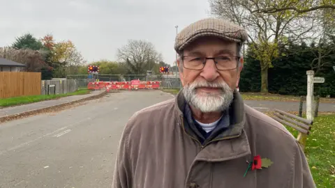 Peter Comber wears a poppy and flat cap for the roadworks on Brooke Road.