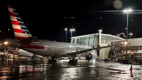 An American Airlines plane sits at a gate at Logan Airport ahead of the July 4th holiday in Boston, Massachusetts, U.S. in a file photo 