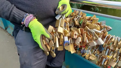 Save the Love Locks at Bakewell Mike Hall holds some of the love locks