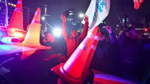 Getty Images Protesters chanting outside the National Assembly building