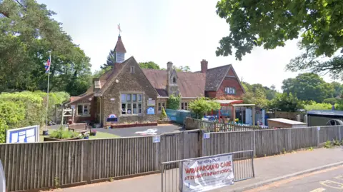 A rural village school on a sunny day. 