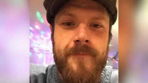 Ben Wright Selfie of a man with a brown beard and flat cap - Ben.