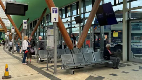 Tom MacDougall/BBC An interior shot of bus gates at Barnsley Interchange.