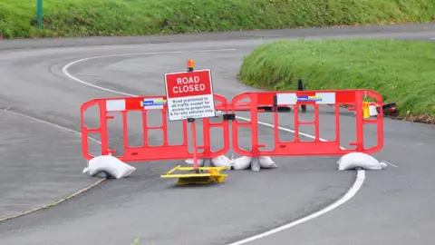 BBC Road closed sign and barriers at the top of Le Val des Terres, Guernsey
