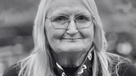 East Lancashire Scouts Black and white head and shoulders of Jennifer Turner in her scour uniform, with long fair hair and wire framed glasses
