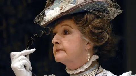 Corbis via Getty Images Penelope Keith as Lady Bracknell. She is looking fierce and peering through her glasses 