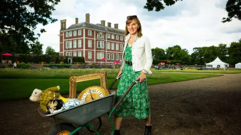 BBC Studios Fiona Bruce with a wheelbarrow of antiques