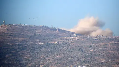 Smoke rises above the occupied West Bank