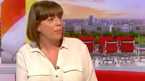 BBC The MP is sat in the BBC Breakfast studio wearing a white shirt with brown hair in a bob style