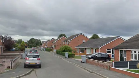 Heron Crescent in Crewe. A Google Maps image. Homes and cars can be seen. 