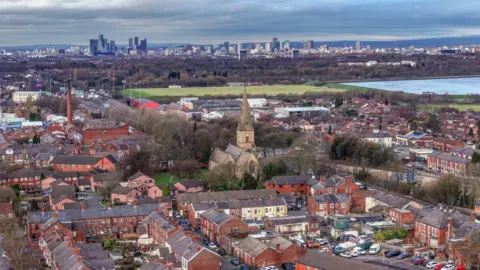 Getty Images An aerial view of homes in Denton and Gorton and the Manchester skyline 