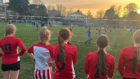 Girls watching the girls football