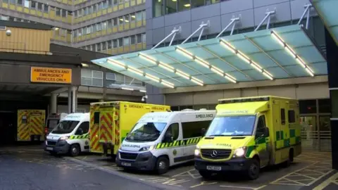 Three ambulances parked outside the accident and emergency department of the Royal Victoria Hospital