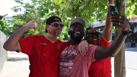 Jack Valpy/BBC Paul Smith, Eric Asare-Mensah and Shermaine Davis take a selfie.