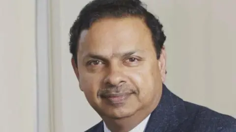 Dr Hemant Ingle A close-up headshot of Dr Hemant Ingle, who looks at the camera while wearing a blue suit jacket and white shirt.