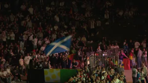 Scotland fan waves flag in fan zone in Munich