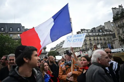 Reuters People attend a demonstration against anti-Semitism in front of Paris City Hall