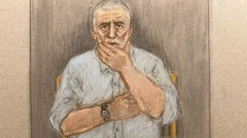 Julia Quenzler/BBC A court sketch showing Peter Sullivan, 68, who has grey and white hair and a blue shirt, holding his hand to his face