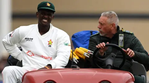 Zimbabwe bowler Richard Ngarava is driven off the field with a back injury
