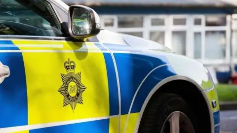 BBC Nottinghamshire Police badge on the side of a police car