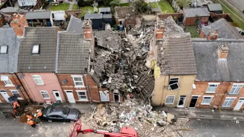PA Media John Street Worksop aerial view with the debris of a house strewn across a street
