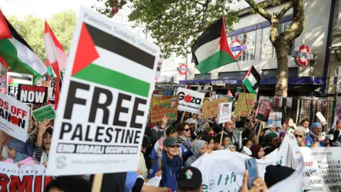 Getty Images Protesters outside Holborn Station holding placards and flags