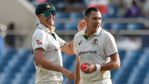 Scott Boland and Pat Cummins celebrate a wicket