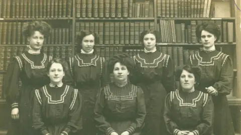 West Sussex Library Service A black and white image of six women in a library in West Sussex. 