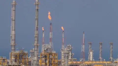 Fire blowing from chimneys at facilities at South Pars gas field