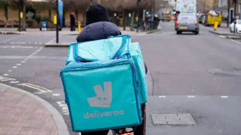 Getty Images A Deliveroo cyclist from behind