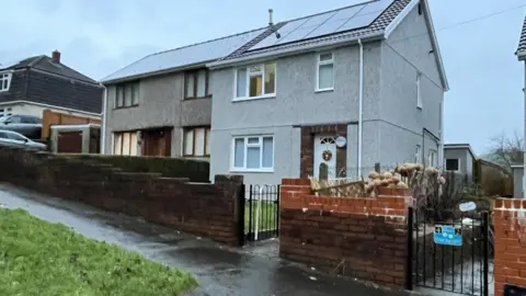 A semi-detached house where Jensen_lee was killed. The house is pebble-dashed and has solar panels on the roof.