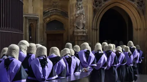 Stock photo of British judges wearing traditional wigs and gowns in procession at Westminster in London in 2017