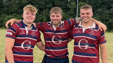 Family handout Jacob (left), with his brothers Ben and Sam Hardwick in red and blue rugby shirts