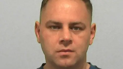 Mugshot of Steve Bulmer. He is clean shaven with short thinning hair.