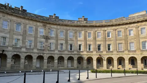 Buxton Crescent building - a crescent shaped building with light coloured brick and three floors of windows 