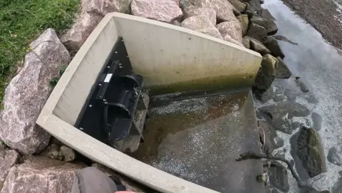 Don Staniford/Abolish Salmon Farming Out tube  with factual  surround, white/silver debris is seen astir   the drain and river, believed to beryllium  food  scales.