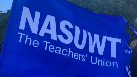 A blue banner with white text reading NASUWT, the teachers' union.