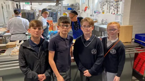 Max, Josie, Ahmed, Arthur. all aged 11, pose in the canteen of their school
